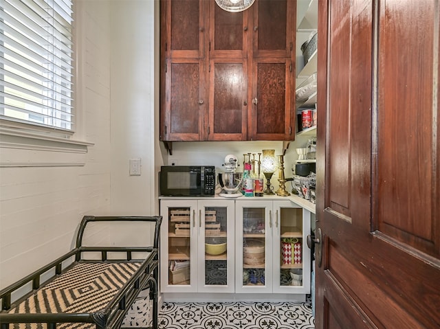 1515 24th St, Galveston, TX 77550 - bar featuring black microwave and light tile patterned flooring