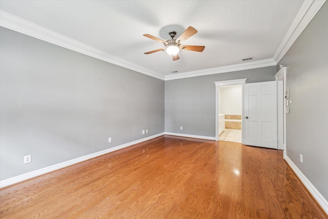 unfurnished room with ceiling fan, crown molding, baseboards, and wood finished floors