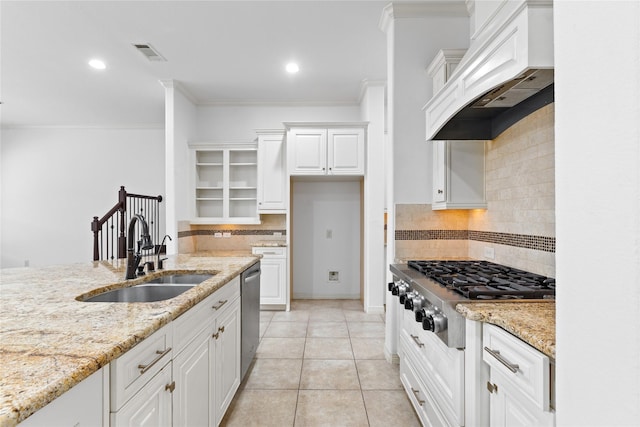 17803 Paint Bluff Ln, Cypress, TX 77433 - kitchen with a sink, custom exhaust hood, stainless steel appliances, white cabinets, and backsplash