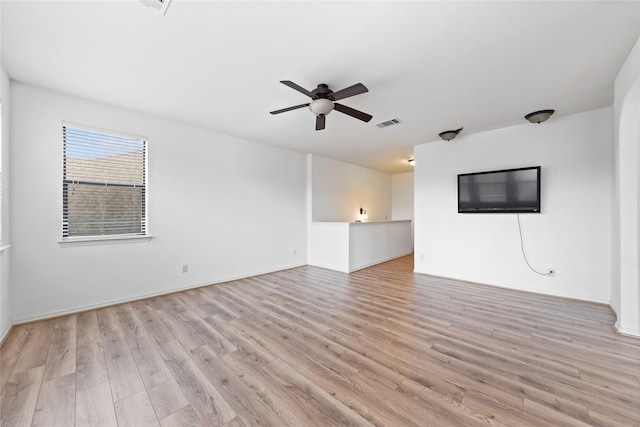 17803 Paint Bluff Ln, Cypress, TX 77433 - unfurnished living room with light wood finished floors, ceiling fan, and baseboards