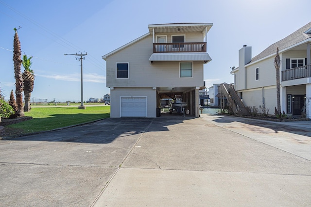 301 Commander Dr, Tiki Island, TX 77554 - view of front facade with a carport, a garage, concrete driveway, a front lawn, and a balcony