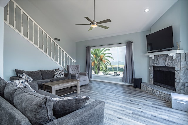 301 Commander Dr, Tiki Island, TX 77554 - living room with stairway, a ceiling fan, wood finished floors, a fireplace, and baseboards