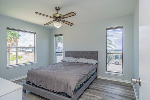 301 Commander Dr, Tiki Island, TX 77554 - bedroom with baseboards, wood finished floors, and a ceiling fan