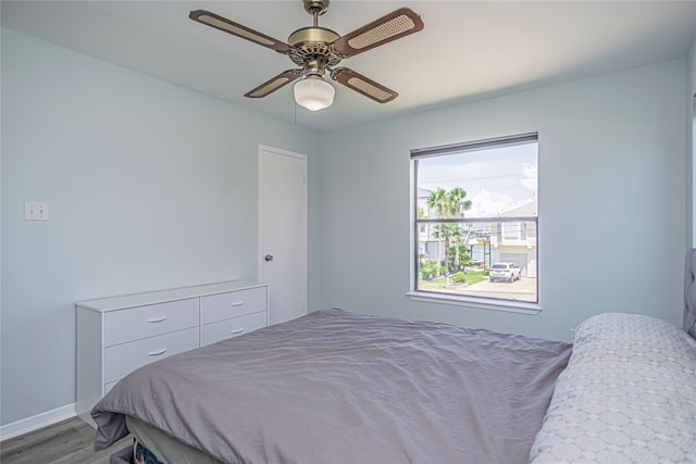 301 Commander Dr, Tiki Island, TX 77554 - bedroom with wood finished floors, baseboards, and a ceiling fan