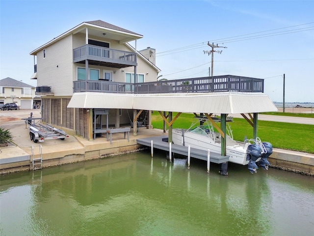 301 Commander Dr, Tiki Island, TX 77554 - dock area with a water view, a balcony, and a lawn