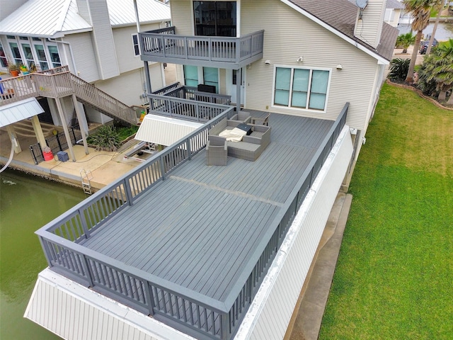 301 Commander Dr, Tiki Island, TX 77554 - back of house featuring a lawn, a water view, and a balcony