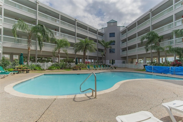 6102 Seawall Blvd Unit 261, Galveston, TX 77551 - community pool with a patio area and fence
