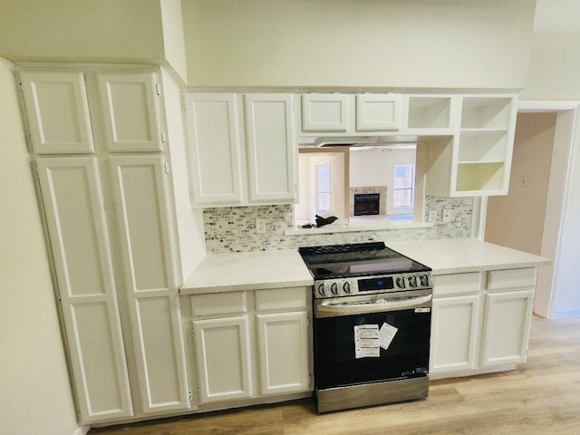2668 Bering Dr Unit 2668, Houston, TX 77057 - kitchen featuring electric stove, backsplash, light wood-type flooring, and light countertops