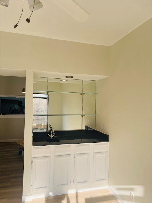 2668 Bering Dr Unit 2668, Houston, TX 77057 - bathroom featuring wood finished floors, baseboards, and a sink