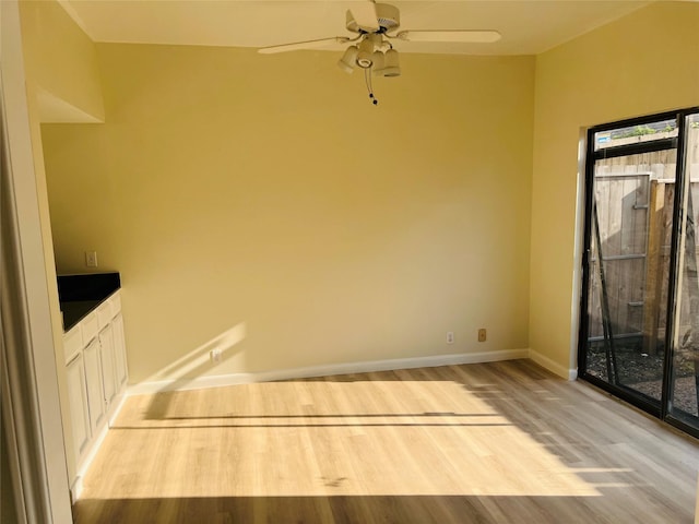 2668 Bering Dr Unit 2668, Houston, TX 77057 - unfurnished dining area featuring light wood-type flooring, baseboards, and a ceiling fan