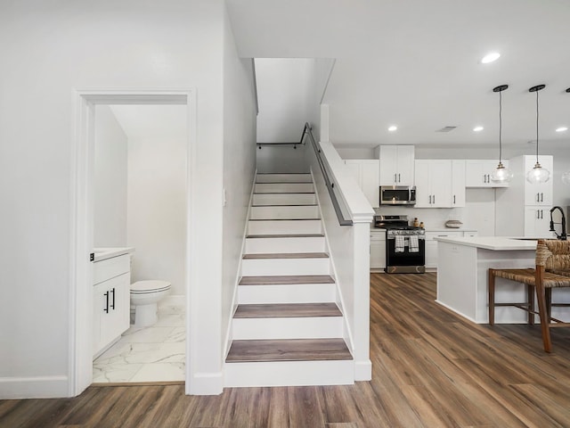 7812 Colonial Ln, Houston, TX 77051 - stairs featuring baseboards, recessed lighting, and wood finished floors
