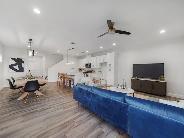 7812 Colonial Ln, Houston, TX 77051 - living area featuring ceiling fan, light wood-style floors, recessed lighting, and baseboards