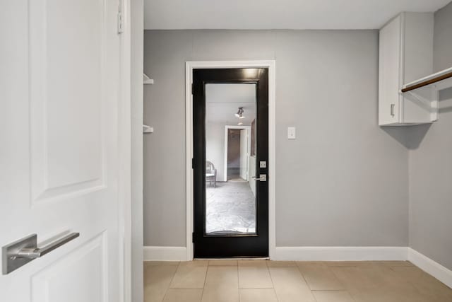 12302 Rincon Dr, Houston, TX 77077 - laundry room with baseboards and light tile patterned floors