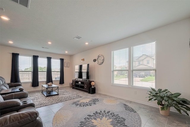 6831 Beck Canyon Dr, Houston, TX 77084 - living room with plenty of natural light, light tile patterned flooring, recessed lighting, and baseboards