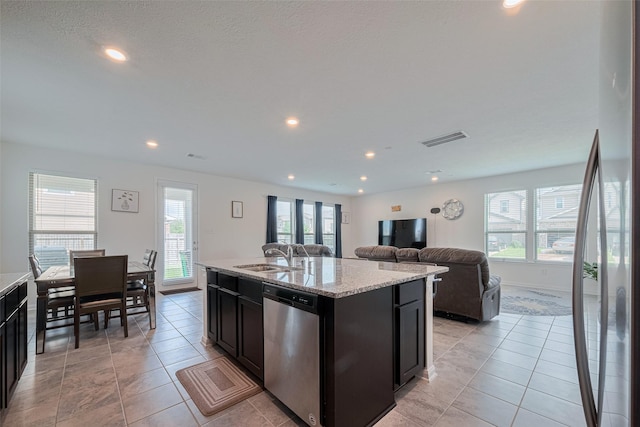 6831 Beck Canyon Dr, Houston, TX 77084 - kitchen featuring stainless steel appliances, recessed lighting, a sink, light tile patterned floors, and open floor plan