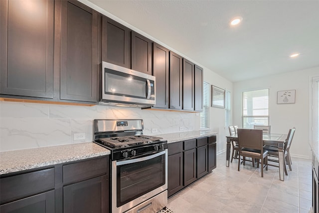6831 Beck Canyon Dr, Houston, TX 77084 - kitchen with stainless steel appliances, decorative backsplash, recessed lighting, dark brown cabinetry, and baseboards
