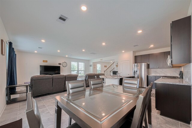 6831 Beck Canyon Dr, Houston, TX 77084 - dining room with recessed lighting, stairs, and light tile patterned flooring
