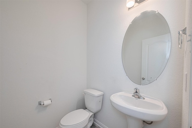 6831 Beck Canyon Dr, Houston, TX 77084 - bathroom with toilet, a sink, and baseboards