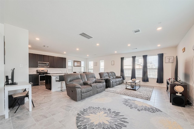 6831 Beck Canyon Dr, Houston, TX 77084 - living room featuring recessed lighting and light tile patterned flooring