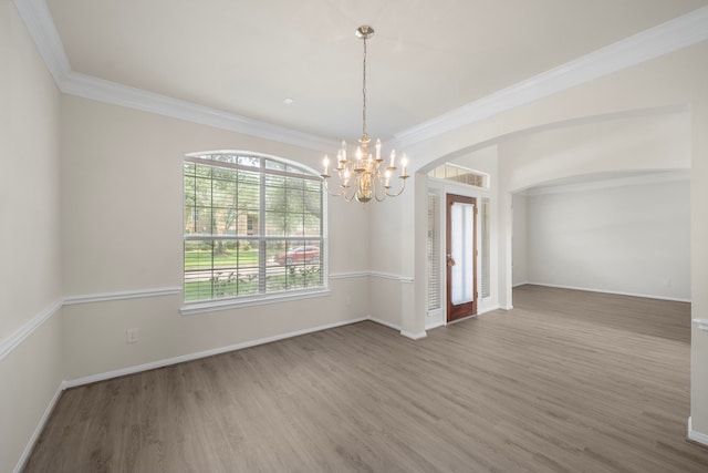 18231 Emerald Stone Ln, Houston, TX 77094 - spare room featuring a chandelier, wood finished floors, arched walkways, baseboards, and ornamental molding