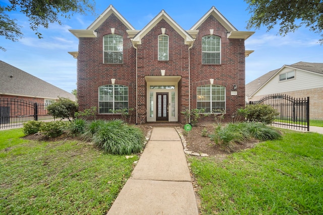 18231 Emerald Stone Ln, Houston, TX 77094 - traditional-style house featuring brick siding, french doors, and a gate