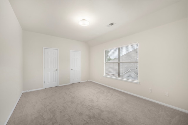 18231 Emerald Stone Ln, Houston, TX 77094 - unfurnished bedroom featuring light colored carpet, baseboards, and two closets