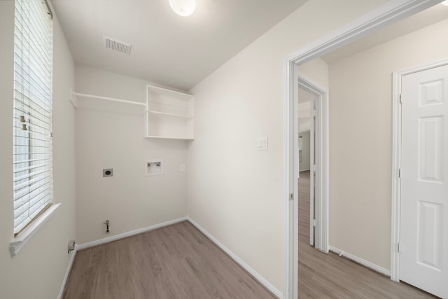 18231 Emerald Stone Ln, Houston, TX 77094 - laundry room featuring hookup for an electric dryer, light wood finished floors, hookup for a washing machine, and baseboards