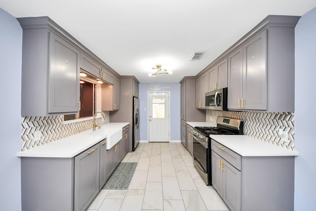 2323 Chalet Rd, Houston, TX 77038 - kitchen featuring stainless steel appliances, a sink, decorative backsplash, and light marble finish flooring