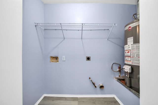 2323 Chalet Rd, Houston, TX 77038 - washroom with water heater, washer hookup, electric dryer hookup, hookup for a gas dryer, and wood finished floors