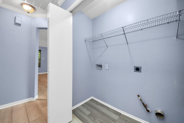 2323 Chalet Rd, Houston, TX 77038 - laundry area featuring gas dryer hookup, hookup for a washing machine, wood finished floors, hookup for an electric dryer, and baseboards