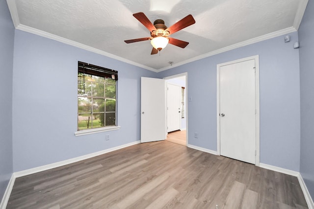 2323 Chalet Rd, Houston, TX 77038 - unfurnished bedroom with wood finished floors, baseboards, ornamental molding, and ceiling fan