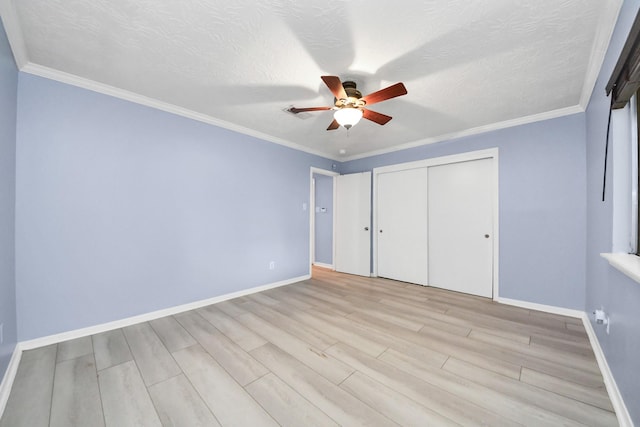 2323 Chalet Rd, Houston, TX 77038 - unfurnished bedroom featuring baseboards, light wood-type flooring, a closet, a ceiling fan, and a textured ceiling