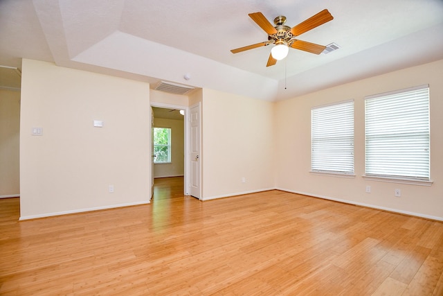 1307 Remington Crest Dr, Houston, TX 77094 - empty room with light wood-type flooring, ceiling fan, baseboards, and a raised ceiling