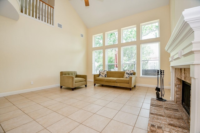 1307 Remington Crest Dr, Houston, TX 77094 - living room with high vaulted ceiling, a fireplace with raised hearth, light tile patterned floors, ceiling fan, and baseboards