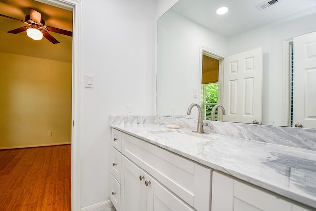1307 Remington Crest Dr, Houston, TX 77094 - bathroom featuring baseboards, vanity, wood finished floors, ceiling fan, and recessed lighting