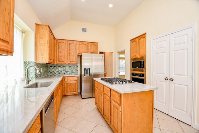 1307 Remington Crest Dr, Houston, TX 77094 - kitchen with appliances with stainless steel finishes, a sink, light stone counters, light tile patterned floors, and decorative backsplash