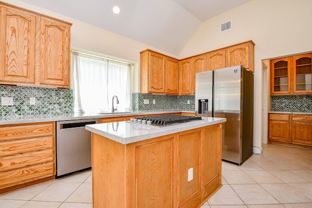 1307 Remington Crest Dr, Houston, TX 77094 - kitchen with stainless steel appliances, decorative backsplash, a sink, light tile patterned floors, and a kitchen island