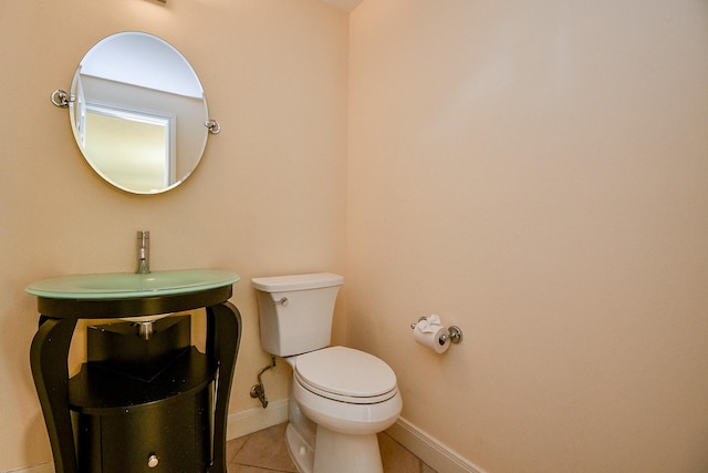 1307 Remington Crest Dr, Houston, TX 77094 - half bathroom featuring toilet, tile patterned flooring, a sink, and baseboards