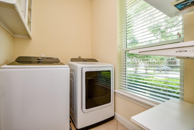 1307 Remington Crest Dr, Houston, TX 77094 - washroom featuring washer and clothes dryer, light tile patterned flooring, and baseboards