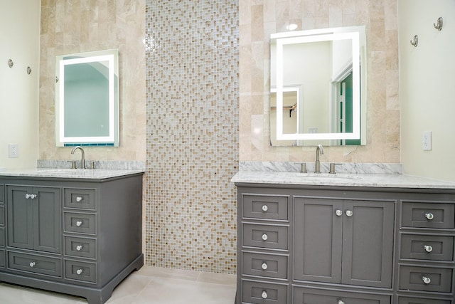1307 Remington Crest Dr, Houston, TX 77094 - bathroom featuring tile walls, two vanities, and tile patterned flooring
