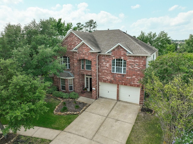 12002 Iris Canyon Dr, Tomball, TX 77377 - traditional-style house featuring a garage, brick siding, a shingled roof, and driveway