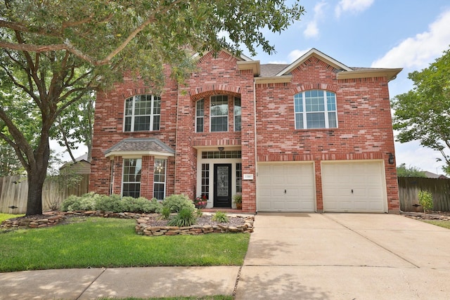 12002 Iris Canyon Dr, Tomball, TX 77377 - traditional-style home with brick siding, concrete driveway, and an attached garage