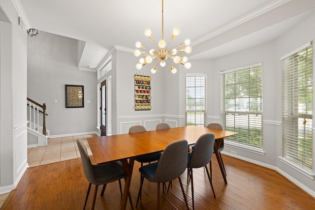12002 Iris Canyon Dr, Tomball, TX 77377 - dining area featuring a chandelier, light wood finished floors, ornamental molding, baseboards, and stairway