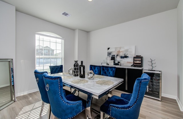 3121 Freeboard Dr, Texas City, TX 77510 - dining area with beverage cooler, baseboards, and light wood-style flooring
