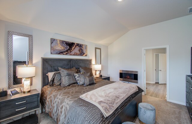 3121 Freeboard Dr, Texas City, TX 77510 - carpeted bedroom featuring lofted ceiling, a warm lit fireplace, and baseboards
