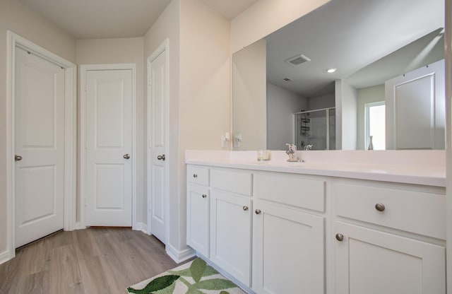 3121 Freeboard Dr, Texas City, TX 77510 - full bathroom with vanity, a shower stall, wood finished floors, and baseboards