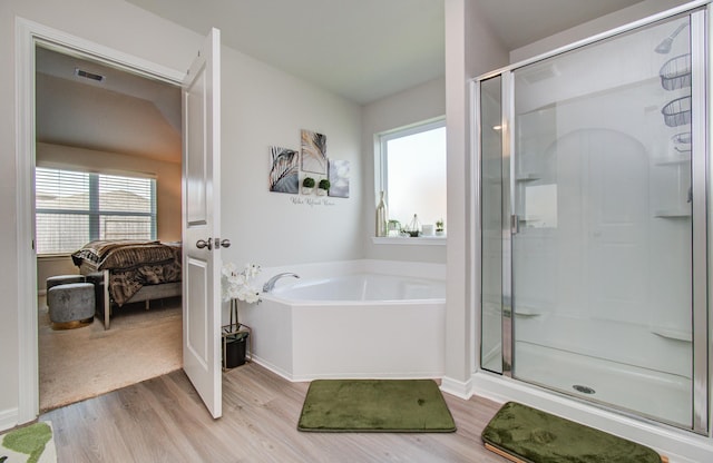 3121 Freeboard Dr, Texas City, TX 77510 - full bathroom with wood finished floors, a stall shower, ensuite bath, a garden tub, and healthy amount of natural light