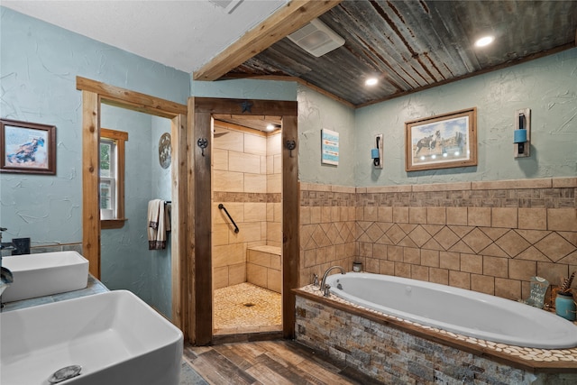 1816 County Road 936b, Alvin, TX 77511 - full bathroom featuring wood finished floors, a textured wall, a garden tub, and a shower stall