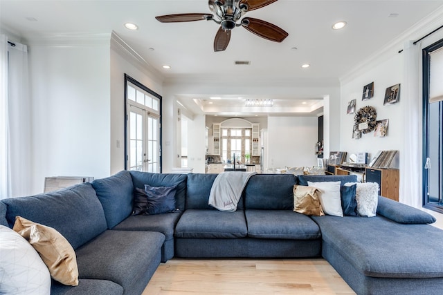 1652 Norfolk St Unit A, Houston, TX 77006 - living room with recessed lighting, crown molding, light wood-style flooring, a raised ceiling, and a ceiling fan