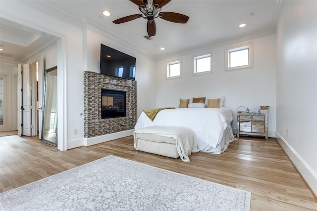 1652 Norfolk St Unit A, Houston, TX 77006 - bedroom with crown molding, wood finished floors, a tiled fireplace, baseboards, and recessed lighting